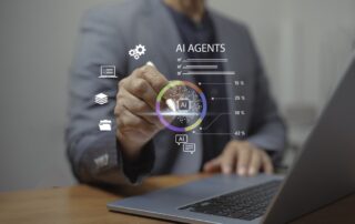 Business professional using a laptop and interacting with a virtual ai agents interface showing colorful analytics and technology icons.